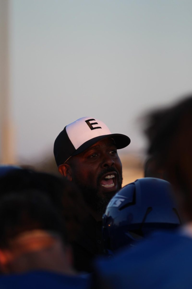 Coach Derrick Lyons motivates the Jets during a halftime speech.