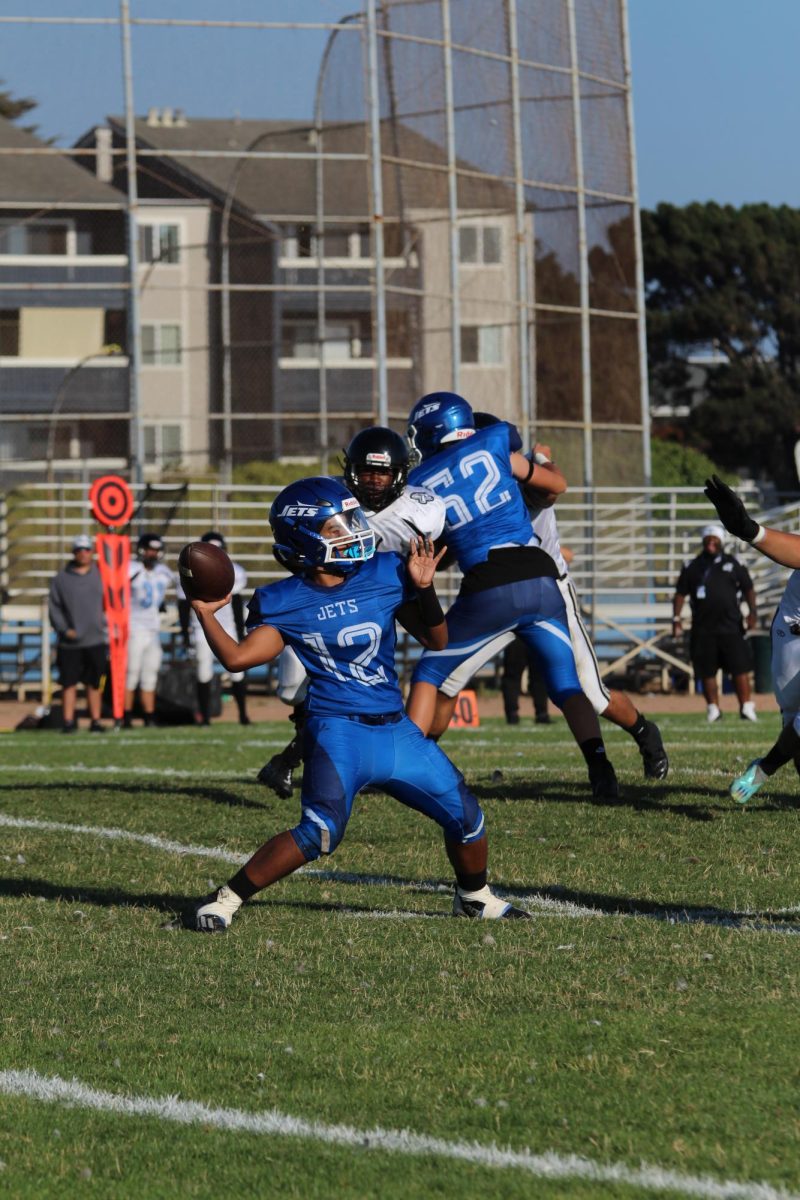Sophomore quarterback Geezy Reyes attempts a pass on August 25.