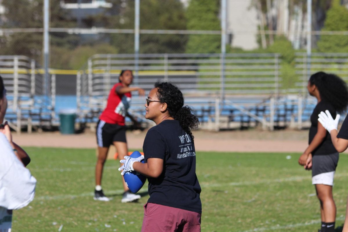 Senior Reagan Caoili warms up her throwing arm on September 7.