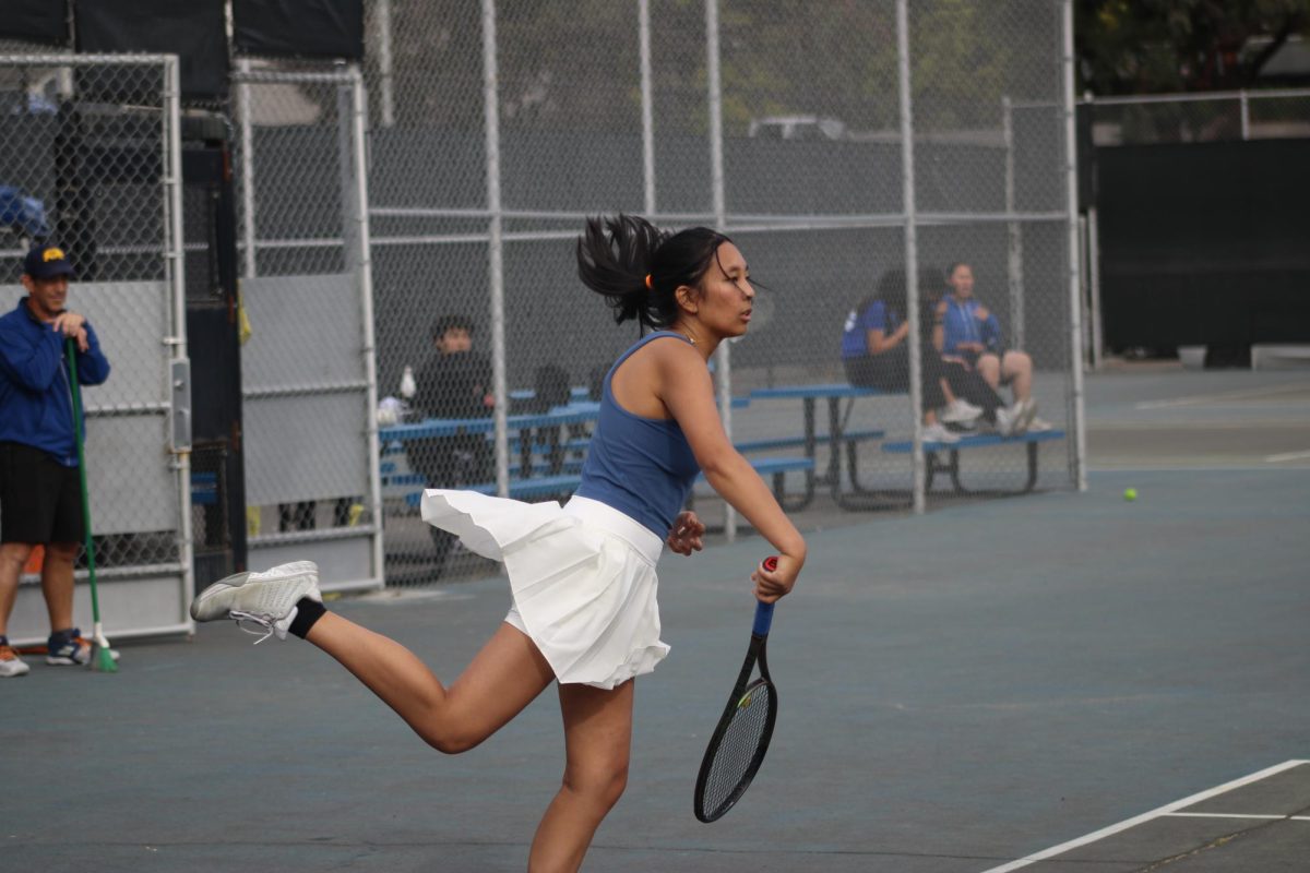 Senior Sofia Layzer finishes a serve against Tennyson on Octtober 13.