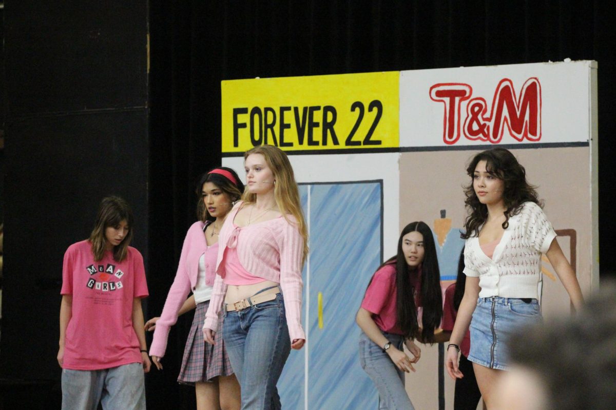 "The Plastics" make their iconic entrance walk to the song 'Meet The Plastics'.