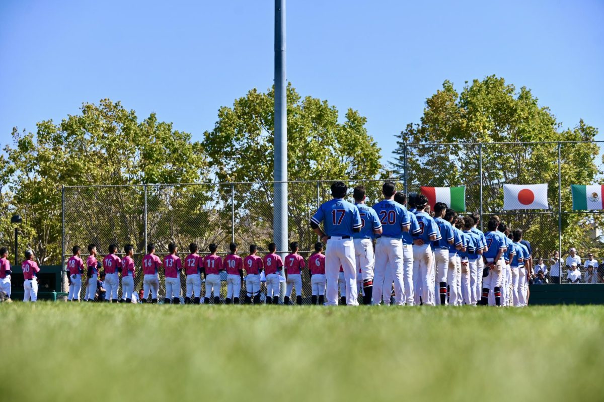 The Alameda world baseball team stands at attention for the nation anthem, along with the Japanese team on 8.9.25.