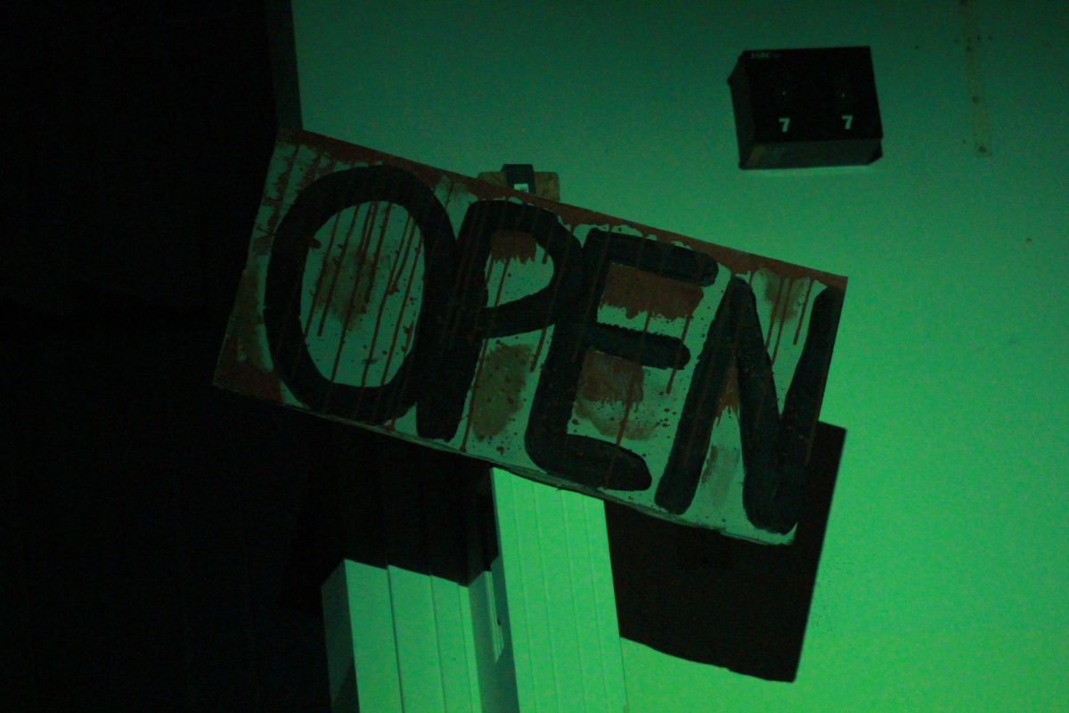 Open sign for Mr. Zyclo's butcher shop on display during Anon(ymous) production on Nov. 21, 2025.