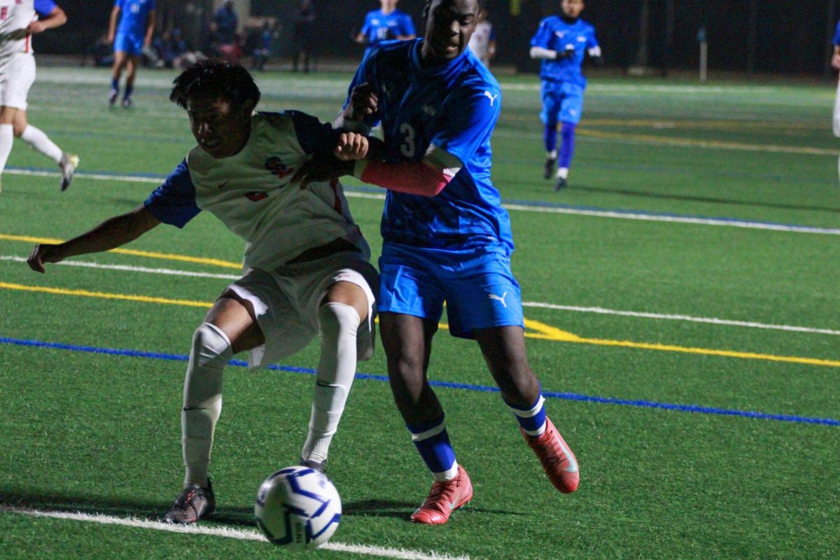 Junior Noah Bositis fights off a San Leandro defender on Dec. 11.