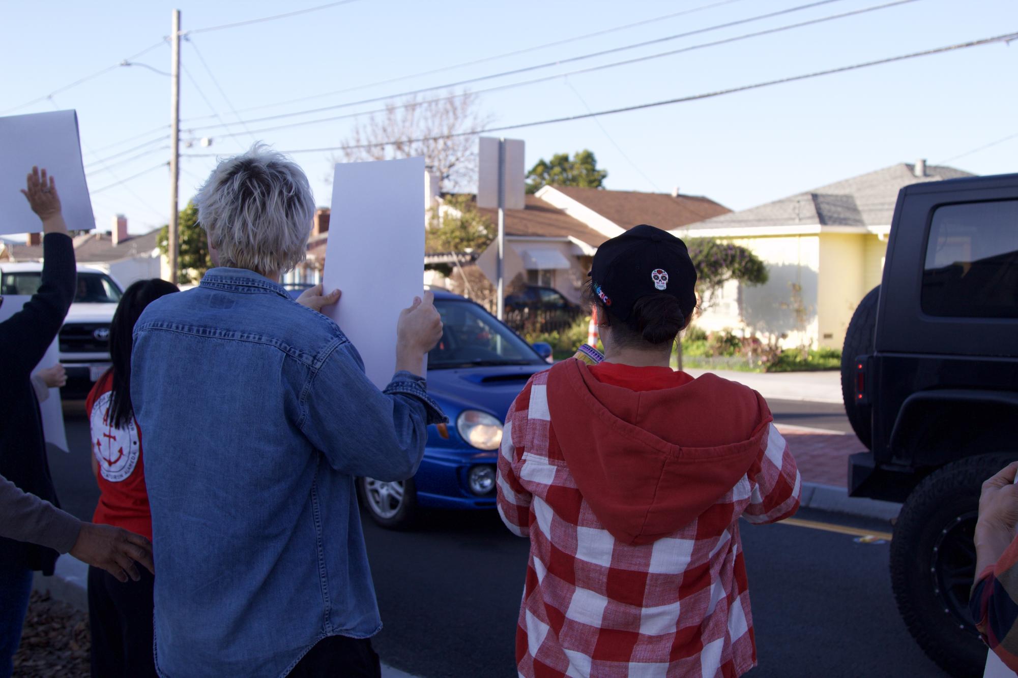 Encinal union leaders Andrew Richner and Melissa Mahfouz hold signs in support of the teachers union on Jan. 21, 2026.