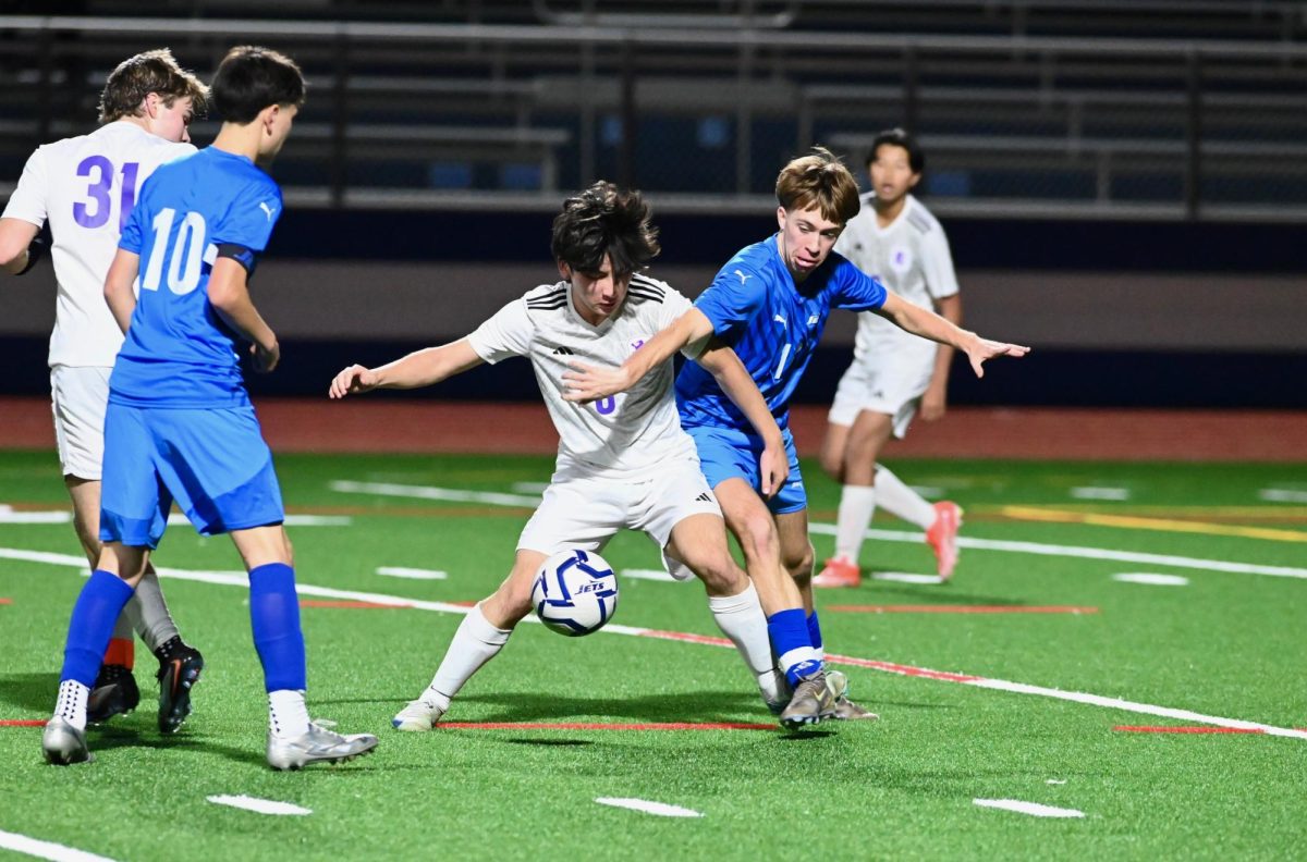 Connor MacDonald (11) fights for possession against Piedmont on Jan. 9