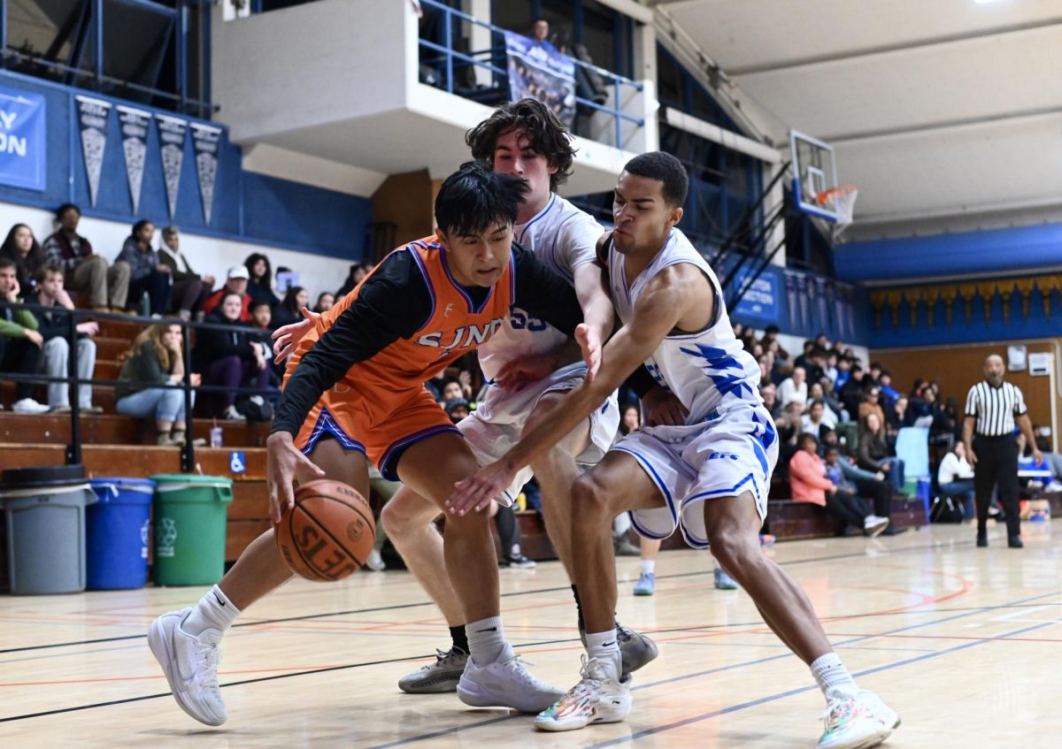 Senior Donovan Heins and junior Orion Juhas defend a Saint Joe's player on Dec. 17. The Jets lost 69-52.