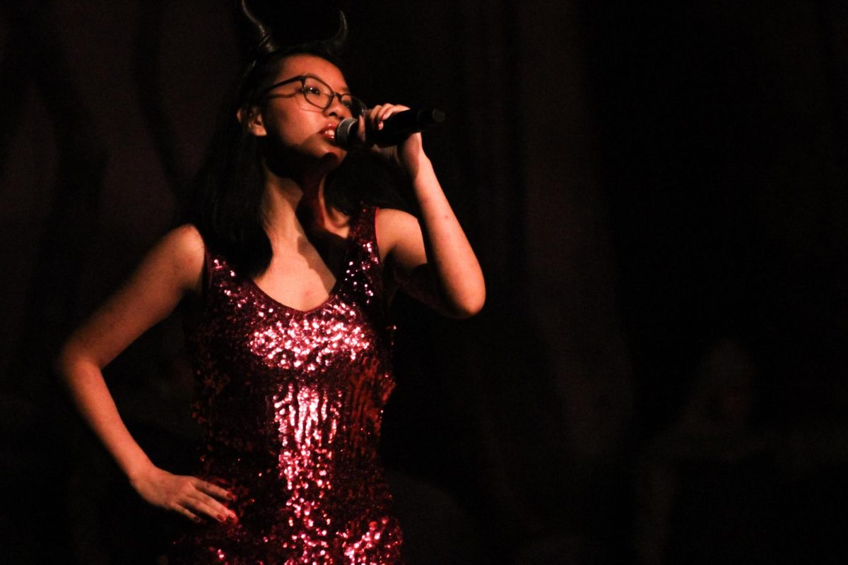 Casey Paano performs onstage as the Dragon in the Encinal Gym on March 20, 2026.