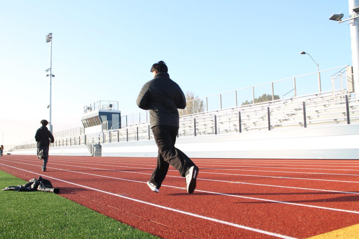 Students run around Encinal's new track during PE class.