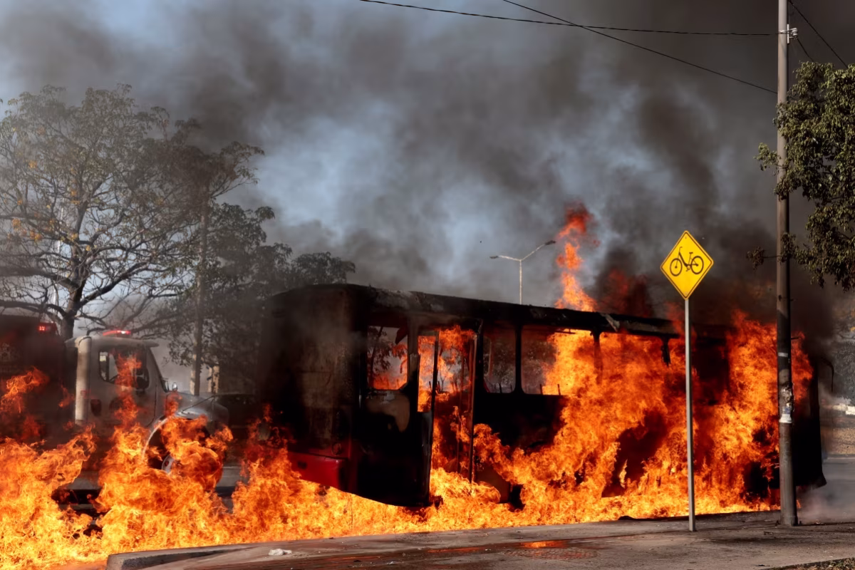 A bus, set on fire by organized crime groups in response to the raid on El Mencho, burns at one of the main avenues in Zapopan, Mexico.