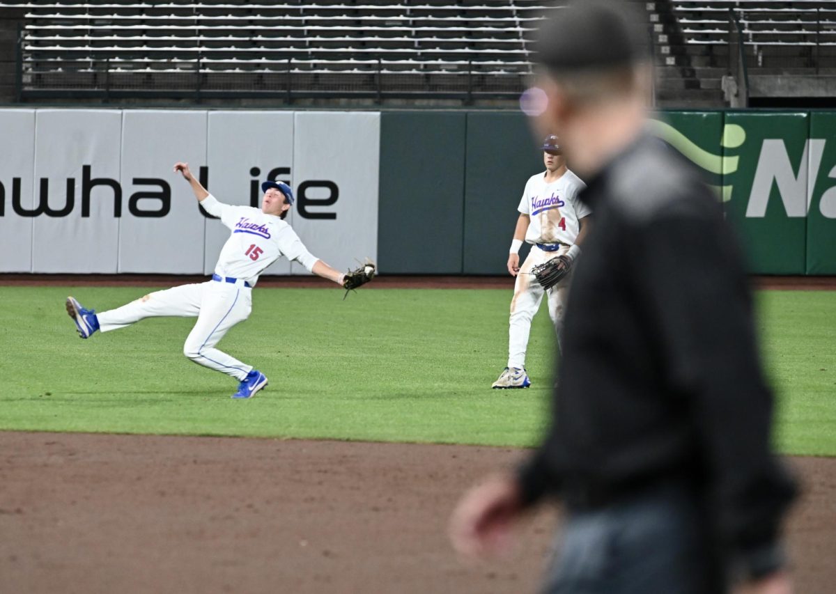 Tamalpais senior Dara Zolfaghari makes a falling catch for an out while Cole Kramlich watches.